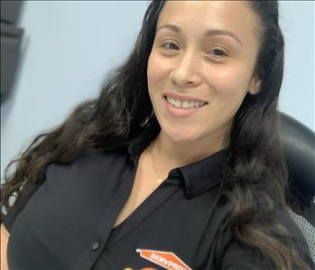 Woman With black SERVPRO polo on, smilling